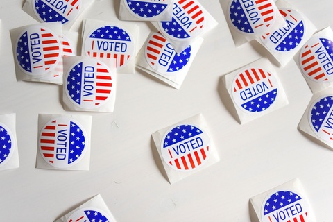 A large number of "I Voted" stickers laying on a surface