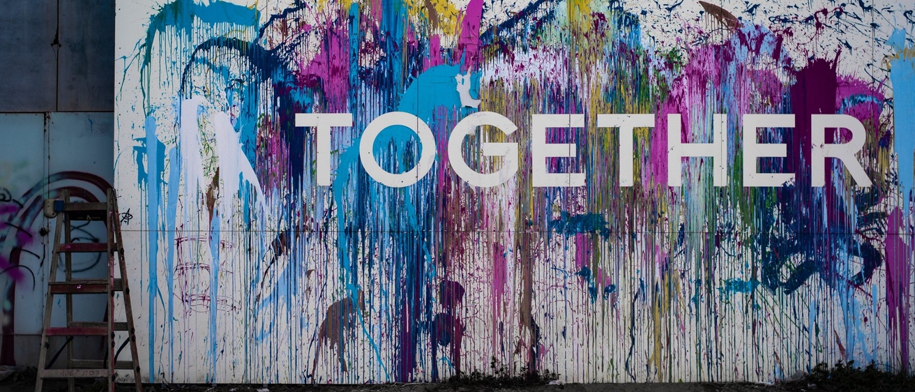 An abstract, colorful painting with the text "Together" overlaid on top