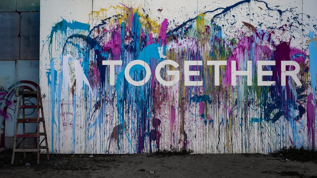 An abstract, colorful painting with the text "Together" overlaid on top