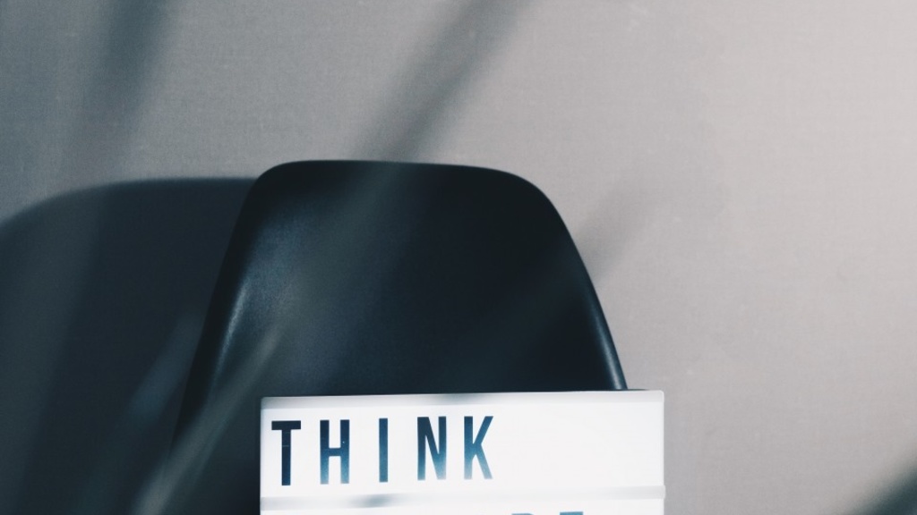 A chair with a sign on it that reads "Think outside the box"